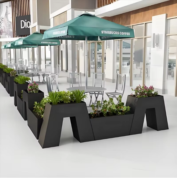 Commercial black metal planter boxes installed at an outdoor entrance
